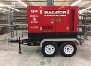 large red Baldor generator mounted on a trailer