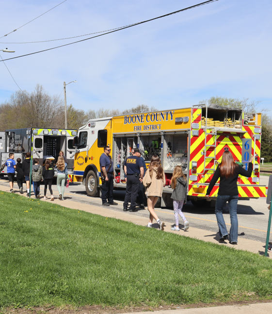 Teenagers walking toward fire and EMS vehicles